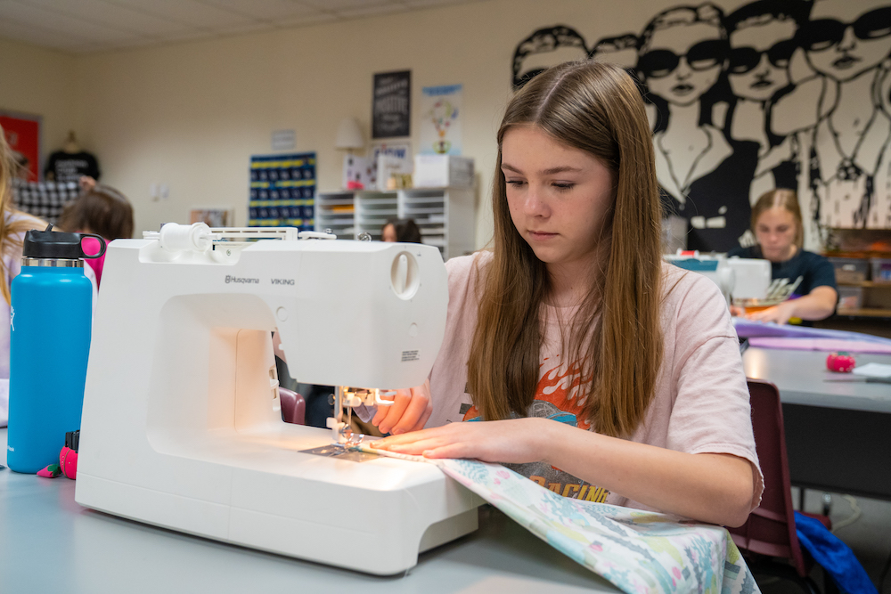Student using sowing machine to make pillowcase